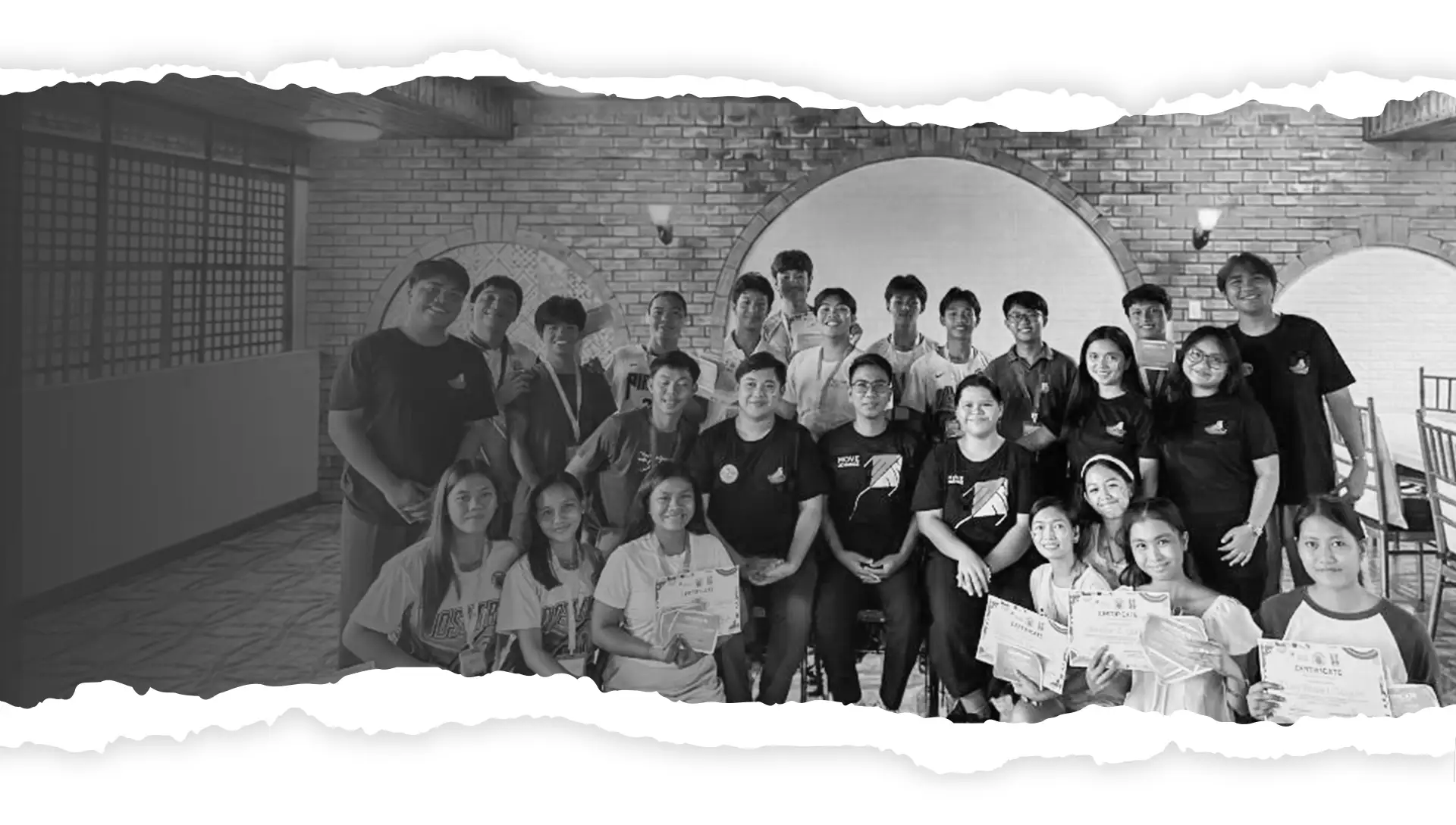 A group of diverse, smiling youth gathered together for community changemaking and volunteer programs.